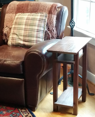 A narrow end table with two shelves handmade from solid walnut fine wood furniture by Mokuzai Furniture